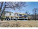 Charming two-story home with a metal roof, covered porch, and well-maintained landscaping at 1103 Wallington Nw Ct, Conyers, GA 30012