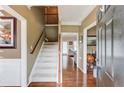 Welcoming foyer with hardwood floors, staircase, and entry to adjacent rooms at 262 Sandhurst Ct, Suwanee, GA 30024