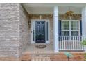 Close-up of the front door with brick facade and decorative welcome mat at 262 Sandhurst Ct, Suwanee, GA 30024