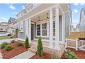 Inviting front porch with brick base and classic white columns at 4002 Potter Way, Woodstock, GA 30188