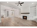 Bright living room with hardwood floors, fireplace, and built-in shelving at 4002 Potter Way, Woodstock, GA 30188