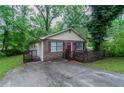 Attractive single-story brick home boasts a quaint, covered porch, plus a paved driveway at 2045 Scarbrough Dr, Stone Mountain, GA 30088