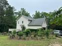 Rear exterior of the house with a well-maintained yard and attached garage at 2377 Centerville Rosebud Rd, Loganville, GA 30052