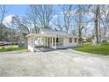 Charming single-story home with covered carport and long driveway at 2826 Ben Hill Rd, Atlanta, GA 30344