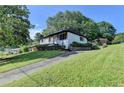 Charming home with a paved driveway, lush green lawn, and mature trees at 3991 Adamsville Sw Dr, Atlanta, GA 30331