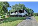 Quaint home with a well-maintained lawn, and a paved driveway at 3991 Adamsville Sw Dr, Atlanta, GA 30331