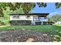 Traditional-style home with landscaped front yard and covered porch entry at 3991 Adamsville Sw Dr, Atlanta, GA 30331