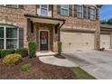 Beautiful brick home with a two-car garage, a covered porch, and a well-manicured lawn at 4305 Hunters Walk Way, Cumming, GA 30028
