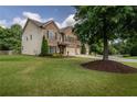 Lovely two-story home featuring a spacious lawn and a charming brick and siding exterior at 4305 Hunters Walk Way, Cumming, GA 30028