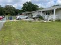 A charming home with a green lawn, bordered flower beds, and a cozy covered porch at 60 King Blvd, Mcdonough, GA 30253