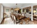 Dining room with a large wood table, decorative lighting, and columns at 1540 Kinglet Ln, Marietta, GA 30062