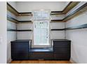 Walk-in closet featuring custom shelves, drawers, and hardwood flooring at 2153 Cooper Lake Se Rd, Smyrna, GA 30080
