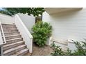 Exterior stairs leading to the home, complemented by a small garden area on the side of the house at 350 Anders N, Chattahoochee Hills, GA 30268