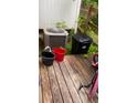 Untidy wooden back deck with trash can, A/C unit, and bicycle needing clean up at 3604 Ginnis Sw Rd # 4, Atlanta, GA 30331