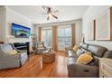 Cozy living room with fireplace, plush seating, hardwood floors, lots of light from large windows at 1858 Preserve Way, Atlanta, GA 30341