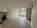 Bright living room with a stone fireplace and ample natural light from large windows at 3722 Cherokee Overlook Dr, Canton, GA 30115