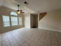 Inviting living room with tile flooring, a ceiling fan, and large windows at 3722 Cherokee Overlook Dr, Canton, GA 30115