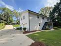 Spacious home with a two-car garage, side staircase, and well-maintained lawn at 1387 Renee Dr, Decatur, GA 30035