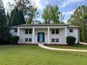 Attractive white brick home with a welcoming front porch and well-manicured lawn at 1387 Renee Dr, Decatur, GA 30035