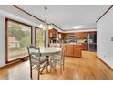 Bright eat-in kitchen boasting stainless steel appliances, hardwood floors and a view to the backyard at 1925 Stonewyck Ct, Cumming, GA 30041