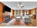 Elegant living room featuring a wood-burning fireplace, hardwood floors and lots of natural light at 1925 Stonewyck Ct, Cumming, GA 30041
