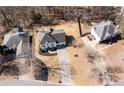 Aerial view of home in quiet neighborhood with mature trees and long driveway at 3519 Wellsley Dr, Powder Springs, GA 30127