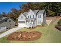 Lovely home with a two-car garage and landscaped front yard at 410 Ward Farm Dr, Powder Springs, GA 30127