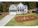 Charming two-story home with a well-manicured lawn and landscaping at 410 Ward Farm Dr, Powder Springs, GA 30127