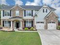 Attractive home featuring a brick and siding facade and a well-manicured front yard at 7104 Secret Rose, Douglasville, GA 30134