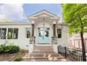 Close-up of the home's covered front entry with brick stairs and a stylish light blue front door at 937 Rosedale Ne Rd, Atlanta, GA 30306