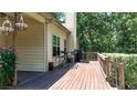 Spacious outdoor deck featuring wood flooring, patio furniture, and wooded view at 34 Laurel Ne Way, White, GA 30184