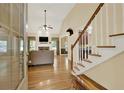 The foyer with a staircase leads to the spacious living room with a fireplace at 34 Laurel Ne Way, White, GA 30184