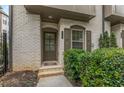 Close up of the front entrance with brick steps and lovely landscaping at 635 Broadview Ne Pl, Atlanta, GA 30324