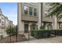 Charming painted brick townhome with iron fence and manicured landscaping at 635 Broadview Ne Pl, Atlanta, GA 30324