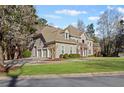 Stately two-story home with a manicured lawn and lush landscaping at 8610 Sentinae Chase Dr, Roswell, GA 30076