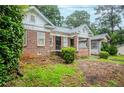 Brick home with a covered front porch and a landscaped front yard at 1615 Stokes Sw Ave, Atlanta, GA 30310