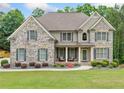Charming two-story brick home with a well-manicured lawn and inviting front porch at 1898 Alcovy Shoals Se Blf, Lawrenceville, GA 30045