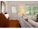 Bright living room featuring hardwood floors, a decorative mirror, and a view to front yard at 2395 Holly Branch Dr, Cumming, GA 30040