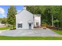 Rear exterior of the home featuring a stone patio, private entrance, and a well-maintained lawn at 270 Park Bridge Ln, Roswell, GA 30075