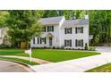 Beautiful two-story home on a corner lot with manicured lawn and mature trees, with a traditional mailbox at 270 Park Bridge Ln, Roswell, GA 30075