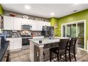 Modern kitchen with granite countertops, stainless steel appliances, and a center island with seating at 510 Curry Ridge Ct, Locust Grove, GA 30248