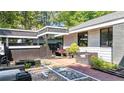 Private backyard stone paver patio featuring black trim, bench seating and an outdoor living area at 1048 Indian Hills Pkwy, Marietta, GA 30068