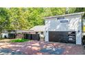 Modern two-story home featuring an attached two-car garage and brick-paved driveway and walkway at 1048 Indian Hills Pkwy, Marietta, GA 30068