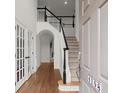 Inviting foyer showcasing hardwood floors, staircase with elegant railings and a view to the second floor at 4108 Wyndam Hill Dr, Suwanee, GA 30024