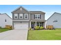 Traditional two-story home with green lawn, two-car garage, and manicured landscaping at 537 Garnet Dr, Acworth, GA 30101