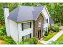 An elevated view of the front of this two-story home with a stone facade and a neatly landscaped front yard at 97 Coral Dr, Whitesburg, GA 30185