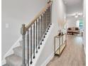 Inviting entryway features a staircase with black iron railing and modern decor at 10151 Benton Woods Dr, Covington, GA 30014