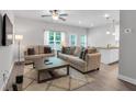 Comfortable living room with open layout, showcasing a view of the kitchen and dining area at 10151 Benton Woods Dr, Covington, GA 30014