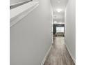 Hallway with wood floors leading to a bright living area, creating an inviting flow at 4076 Sonoma Wood Trl, Decatur, GA 30034