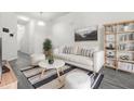 Bright living room with a white sofa, stylish rug, and ample natural light at 4076 Sonoma Wood Trl, Decatur, GA 30034